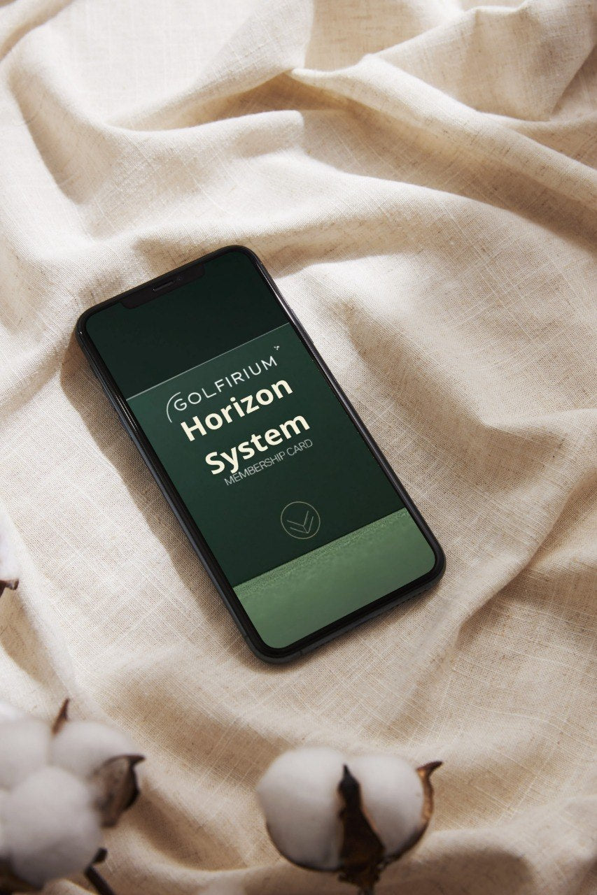 Smartphone displaying 'Golfiru Horizon System' on a textured fabric background