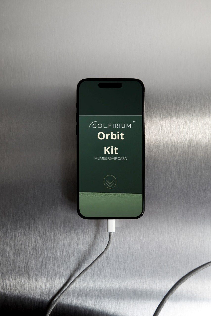 Smartphone displaying the 'Golfiriu Orbit Kit' app on a metallic surface