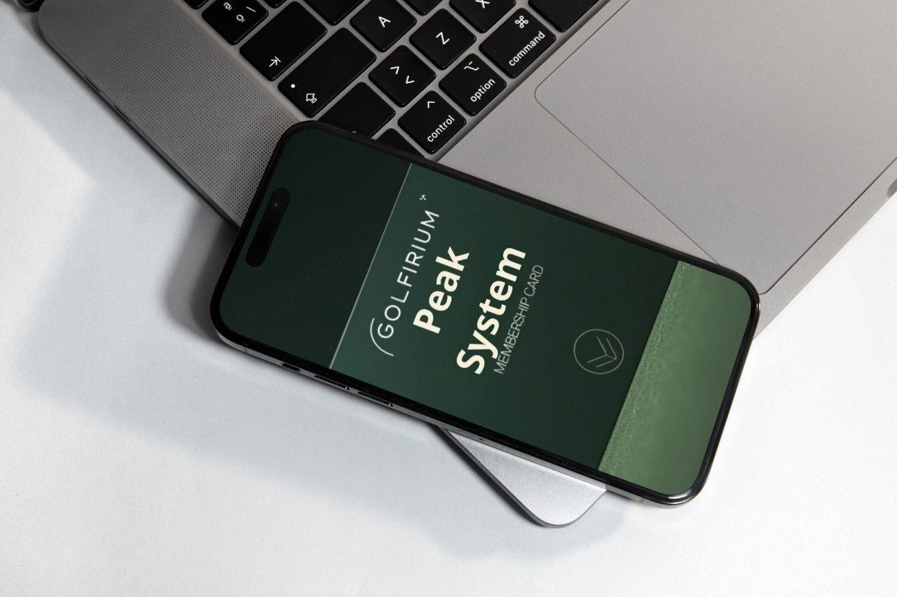 Phone displaying 'Golfiru Peak System' on a laptop